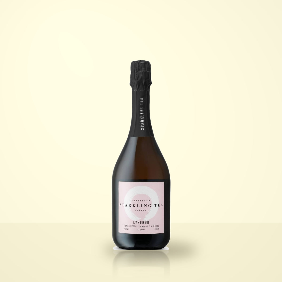 Copenhagen Sparkling Tea Lyserod alone on a cream studio background. Label reads COPENHAGEN SPARKLING TEA COMPANY, LYSEROD, SILVER NEEDLE / OOLONG / HIBISCUS, 0%vol, organic, 75cl.