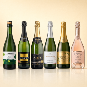 The Sparkling Six — Lussory Organic Brut, Lussory Premium Brut, Pierre Zéro Chardonnay, Le Petit Étoilé Chardonnay, La Tautila Espumoso and Prima Pavé Rosé Dolce, six 0.0% alcohol-free sparkling bottles.
