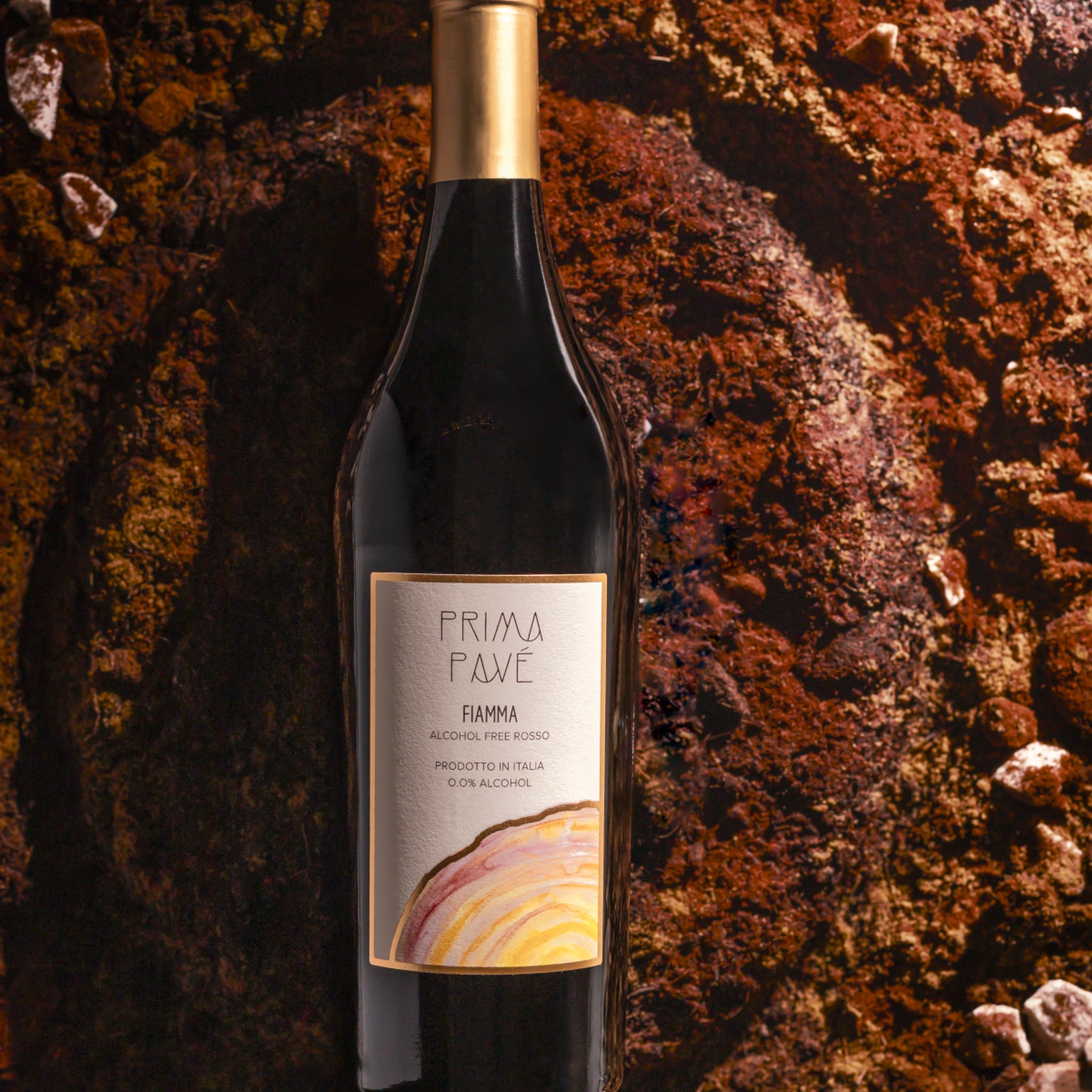 Prima Pavé Fiamma 0.0% bottle on Puglian earth and stone
